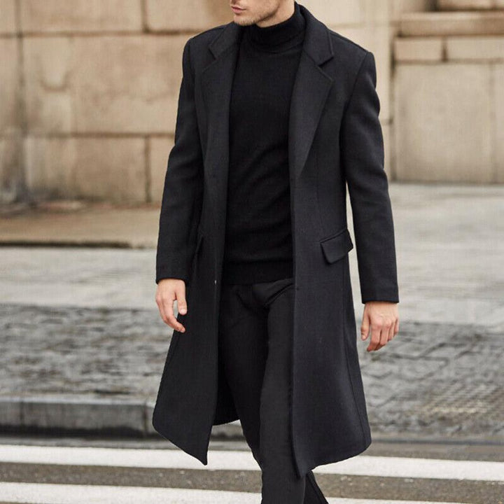 Men's Wool Trench Coat | Classic Longline Style — front view in dark charcoal against a stone wall